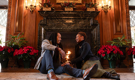 couple sitting by fireplace