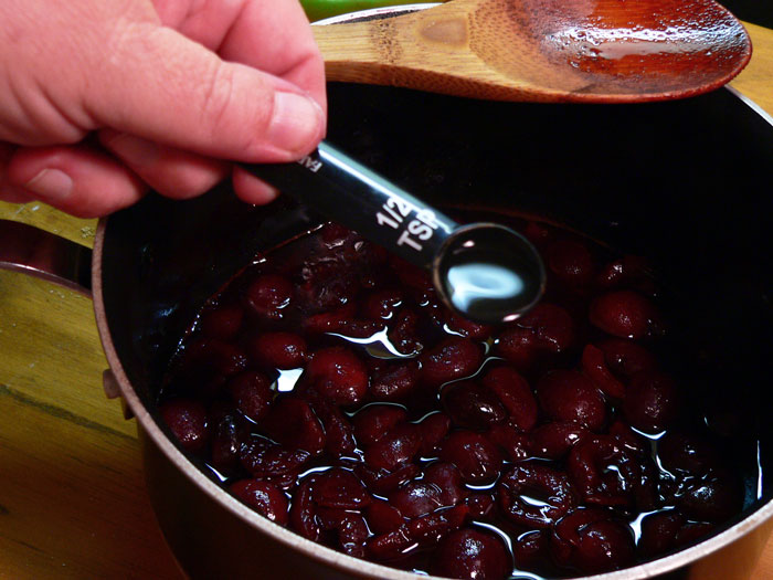 When the Cheerwine has reduced down to about one cup of liquid on the stove, remove the saucepan from the heat. Add in the almond extract and give it a good stir.