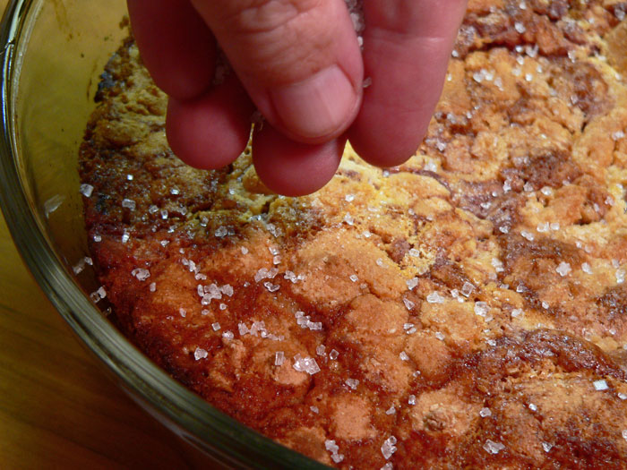 You're just baking the cobbler to get the topping part done. You can test that by inserting a toothpick into the thicker dough sections. If it pulls out clean, other than juice, then the cobbler should be fully baked. Remove it from the oven and place on a towel or wire rack to cool. I like to add some sugar sprinkles to the top just after taking it out of the oven.