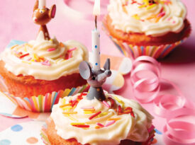 Strawberry cupcakes topped with birthday candles