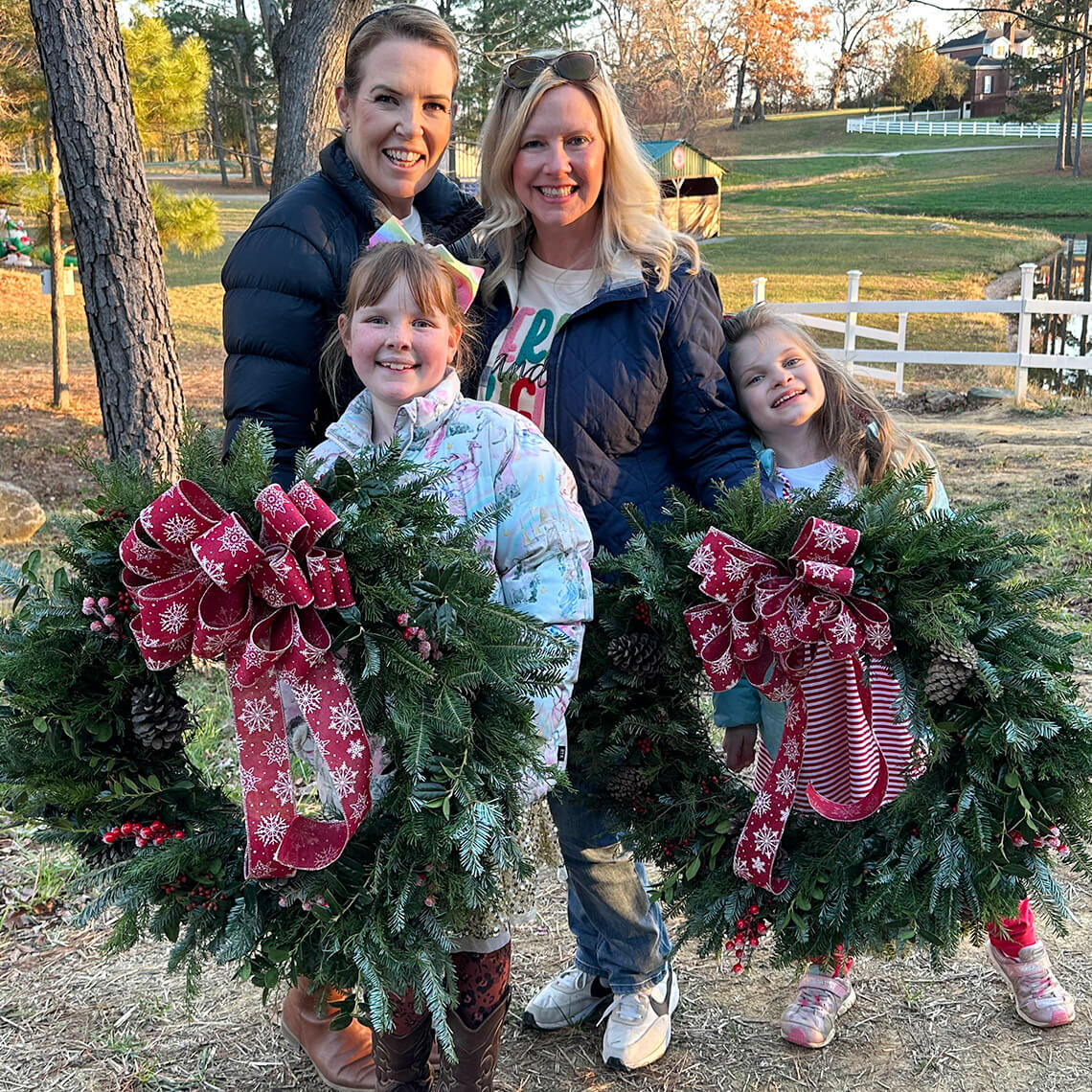 Mothers and children hold wreaths at Millstone Creek Orchards