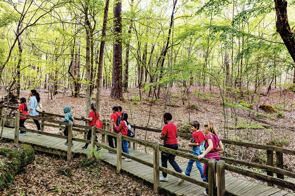 Students walk through Clemmons Educational State Forest