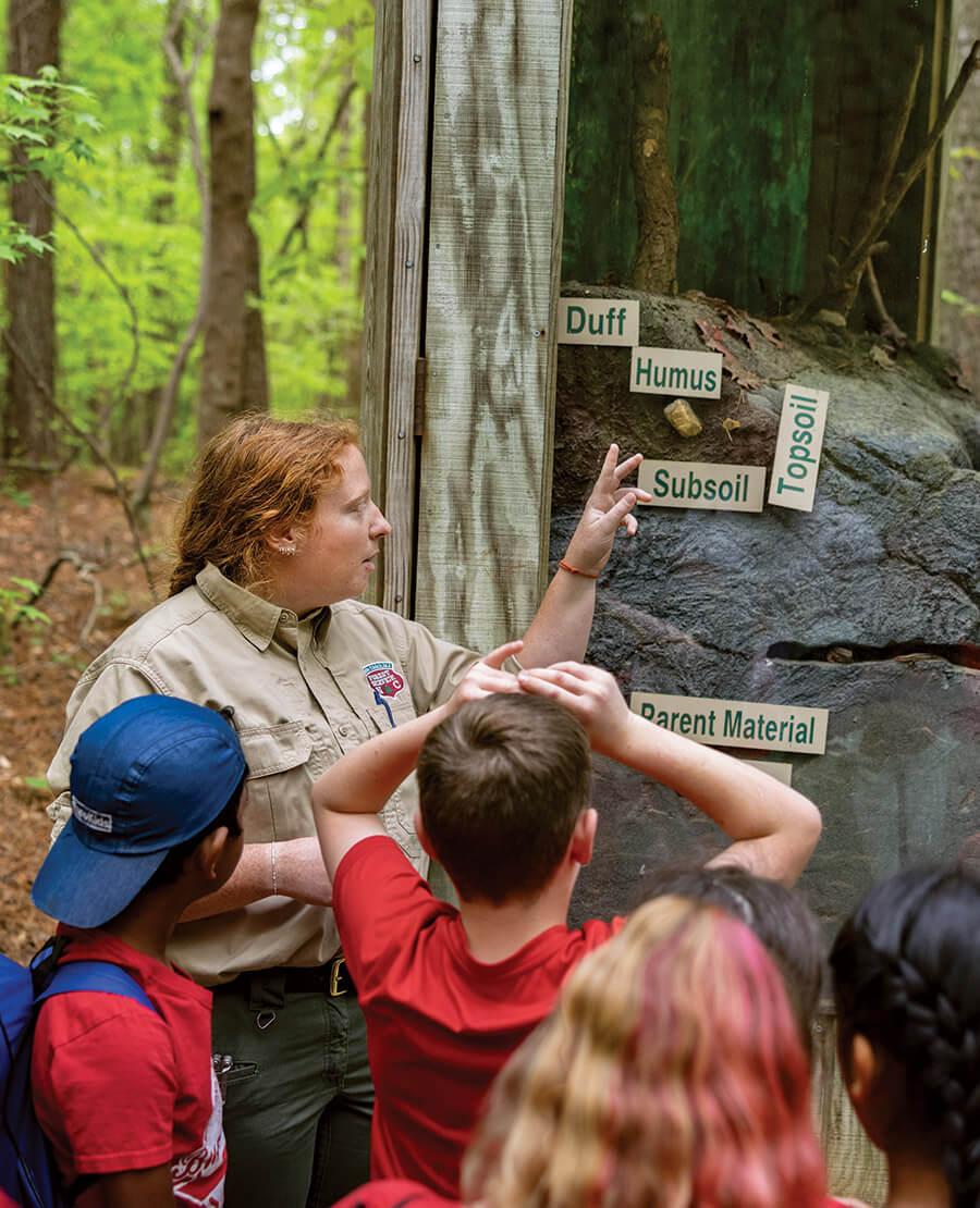Ranger Gracie Brindle instructs students visiting Clemmons Educational State Forest