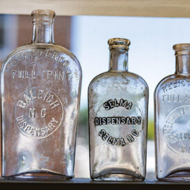 Glass bottles on a shelf at Country Boy Antiques