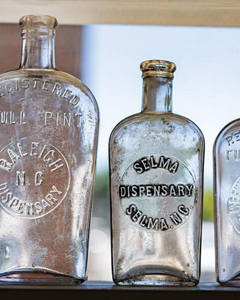 Glass bottles on a shelf at Country Boy Antiques
