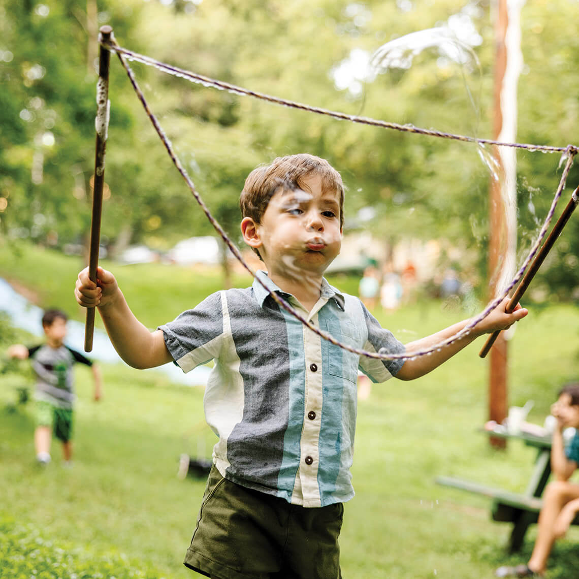Little boy blowing bubbles