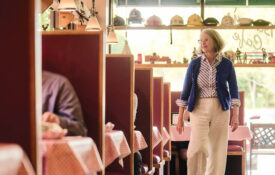 Denise Doyle strides between the booths at Barry's Cafe