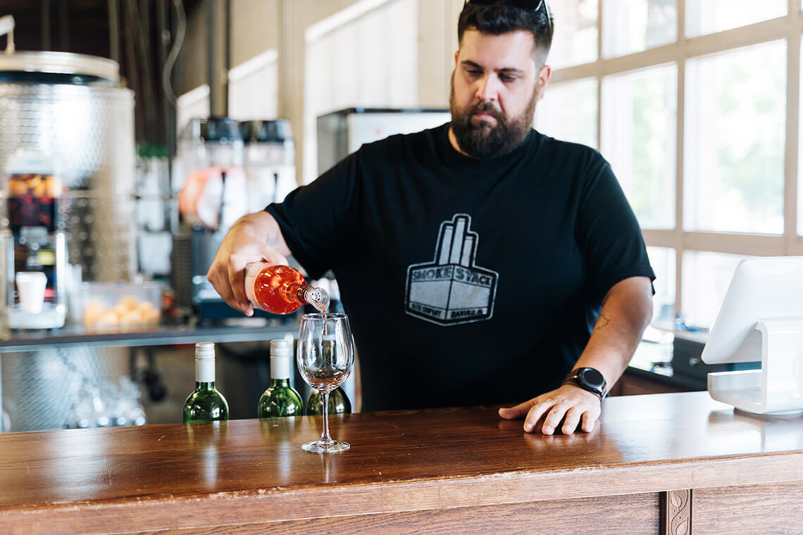 Man pours wine at 2Witches Winery & Brewing Company in Danville, VA