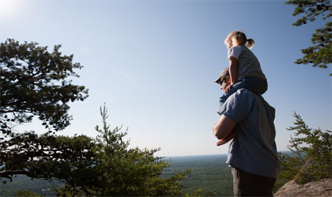 Father and daughter with scenic view