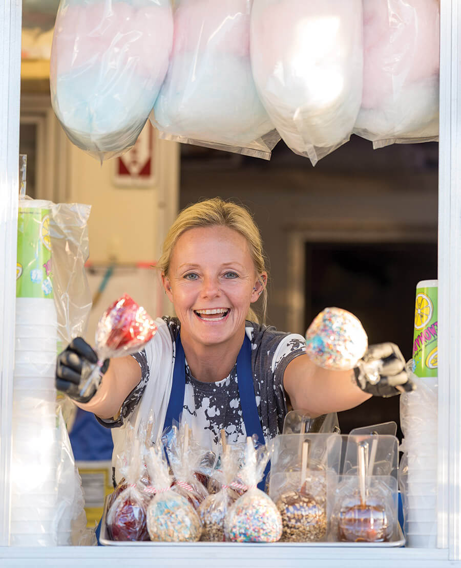 Woman holds candied apples at the state fair