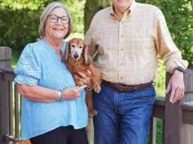 Ray Russell, Rhonda Russell, and their dachshund, Rudy.
