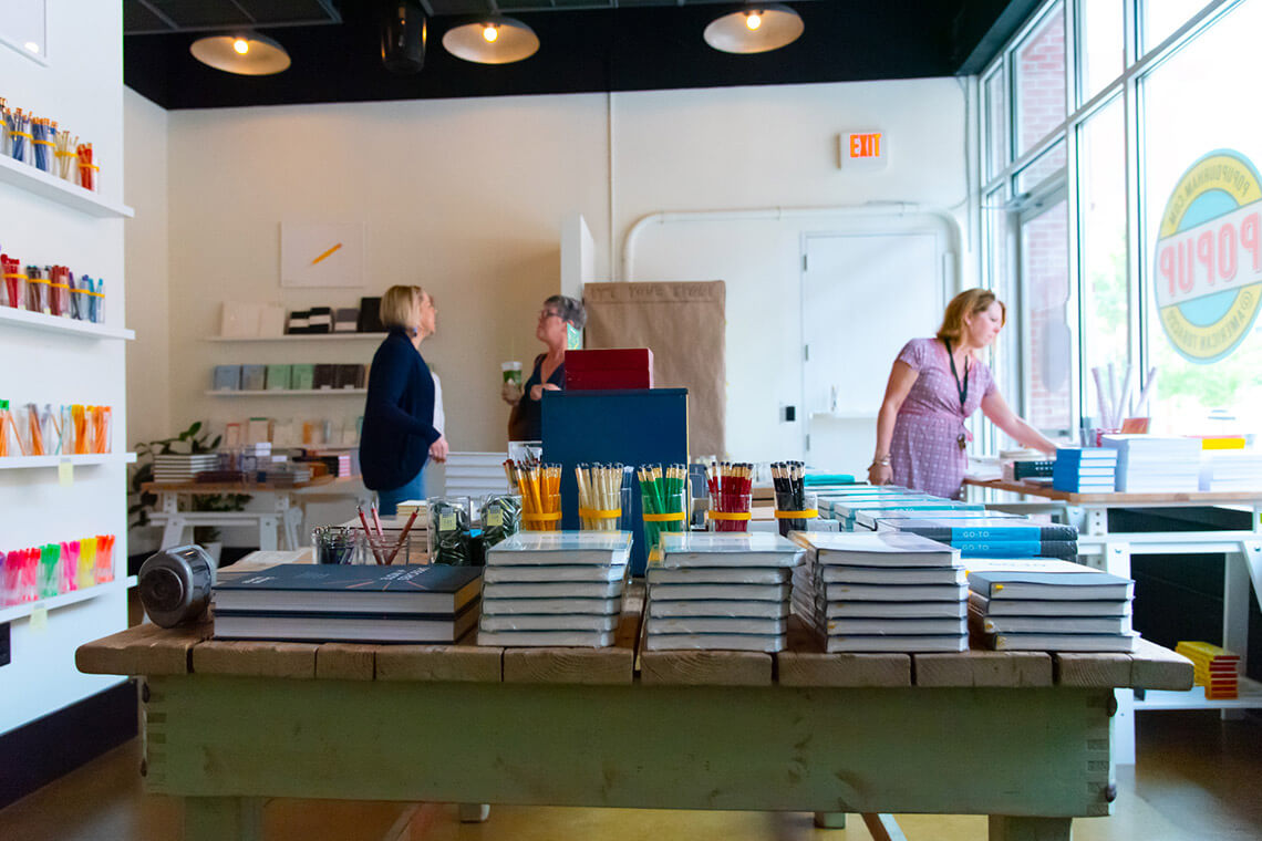 Interior of Parker & Otis with stacks of books