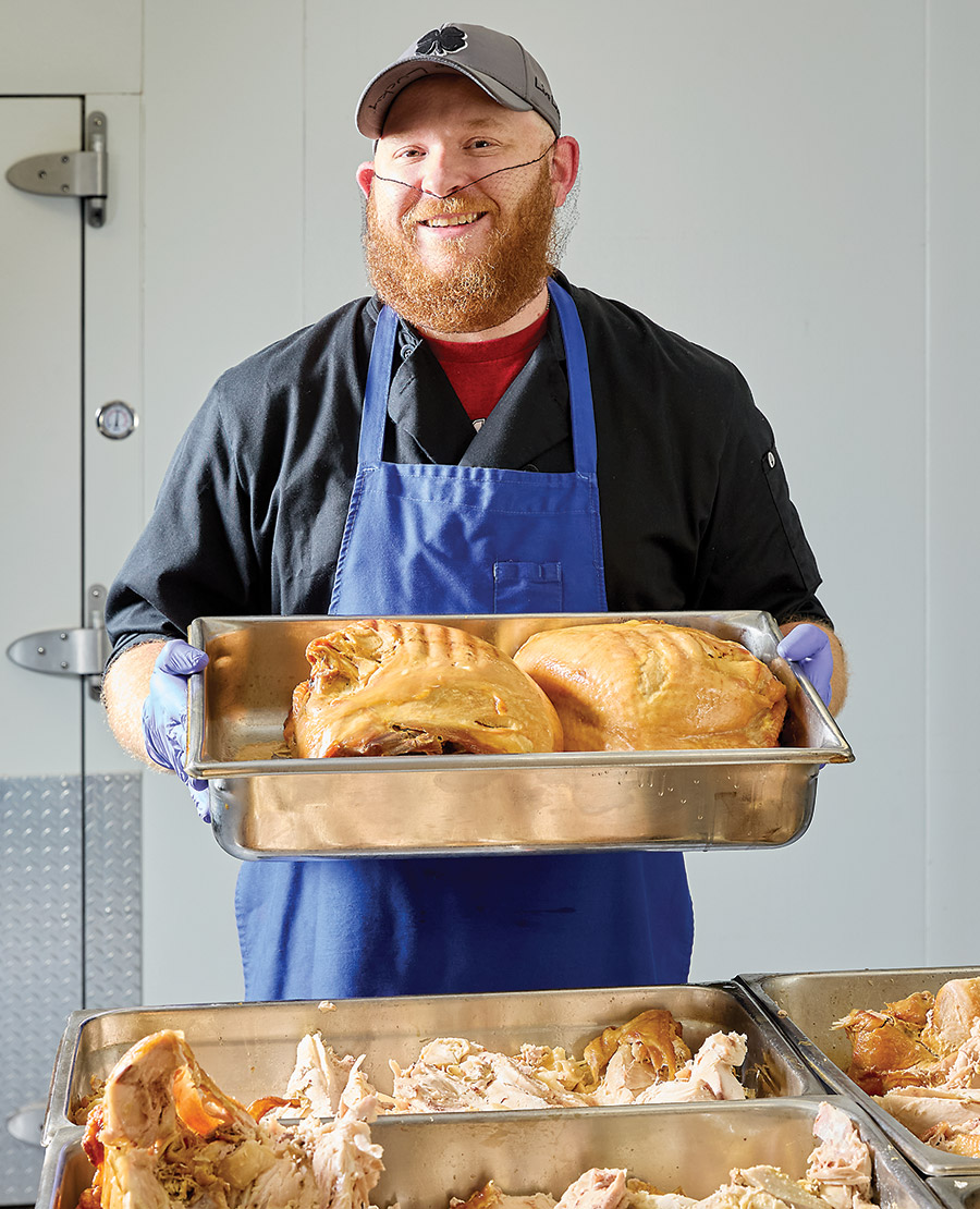 Volunteer Andy Allen prepares turkey for Cabarrus Meals on Wheels