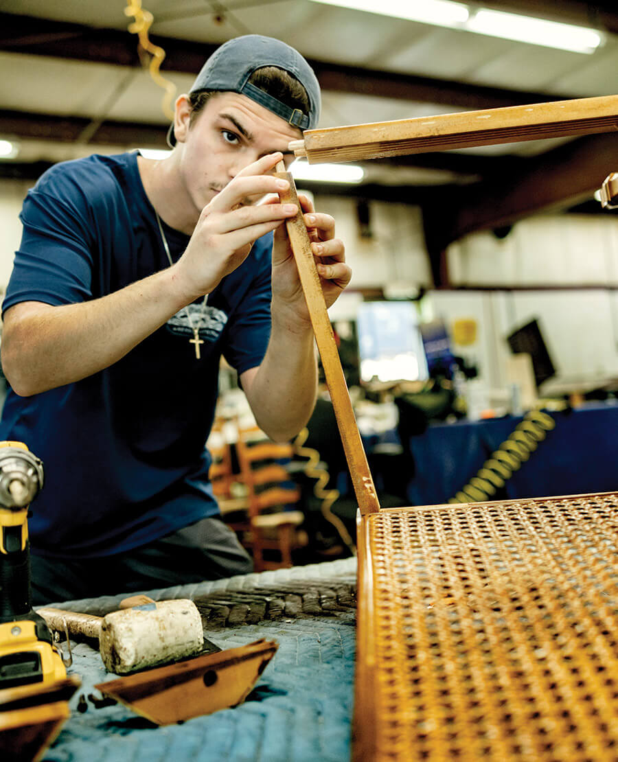 Luke Kayser working on a chair at Mumford Restoration