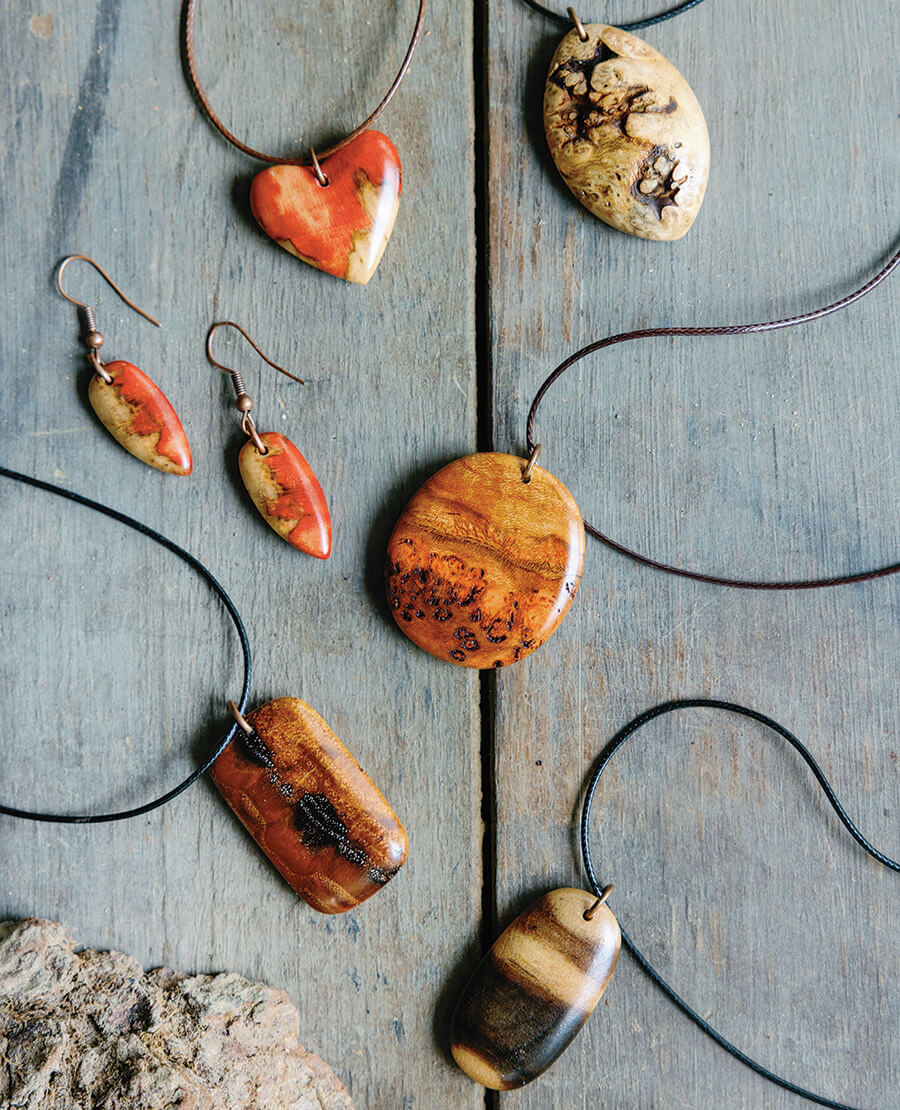 Pieces of jewelry crafted from fallen trees