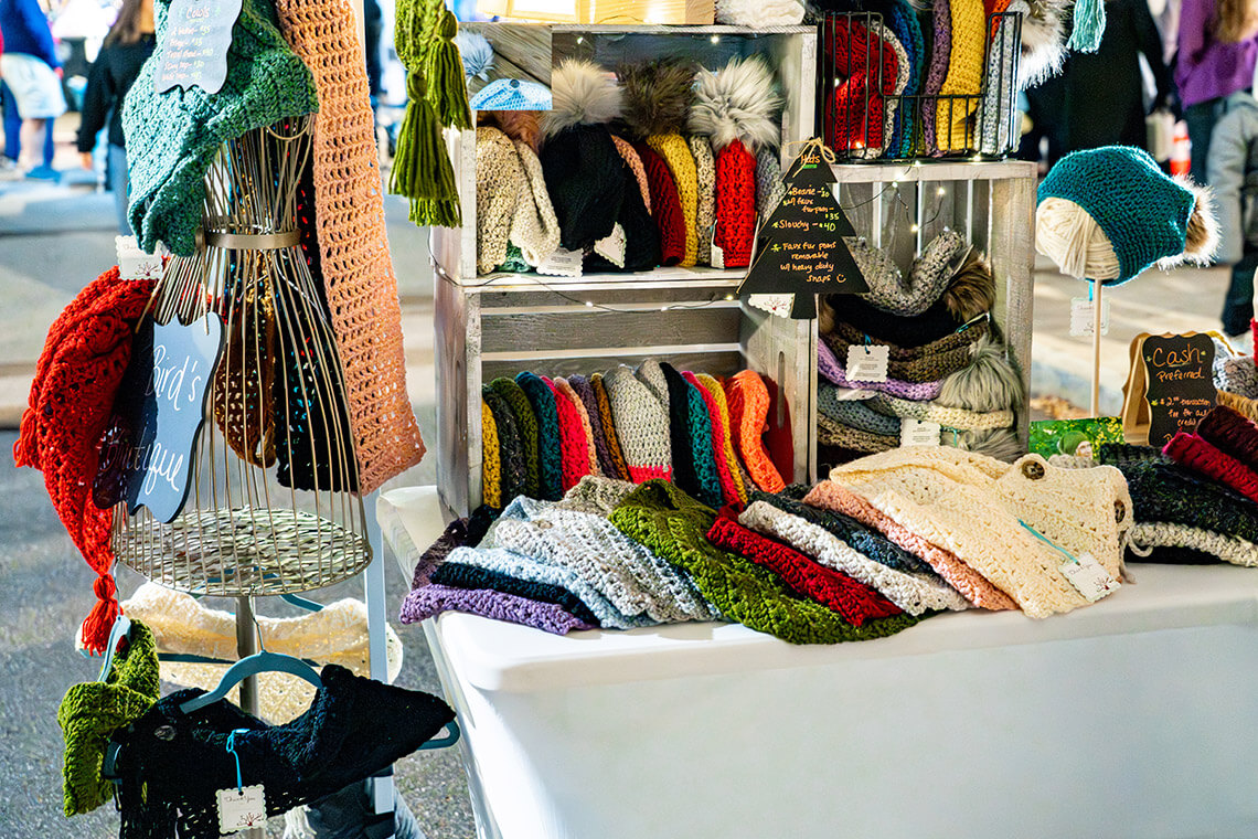 Table with handmade hats and scarves