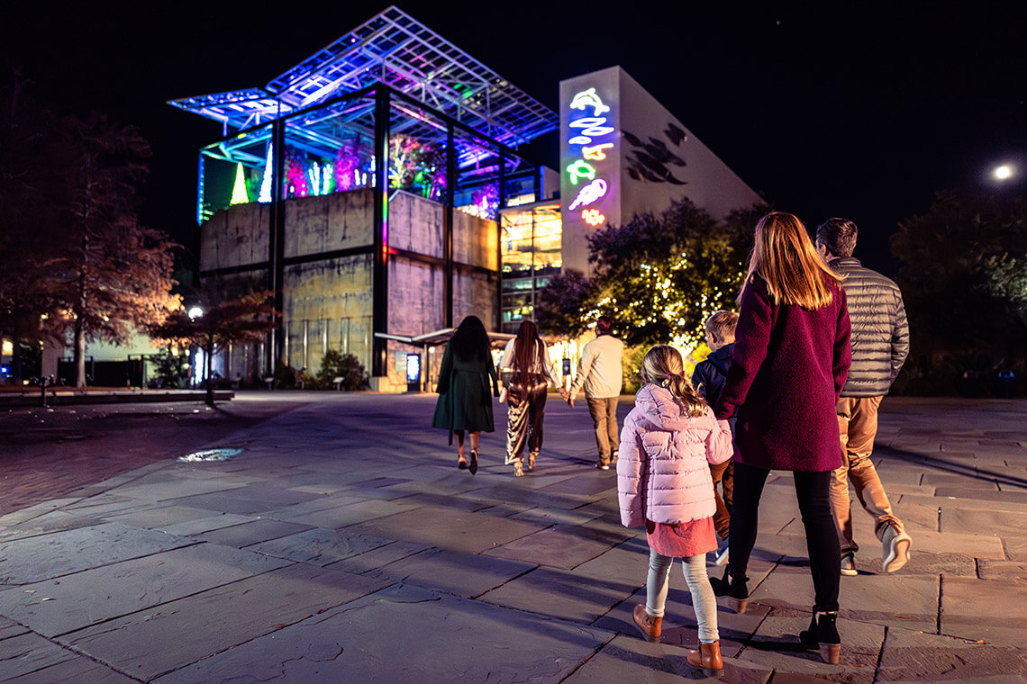 Visitors approach the South Carolina Aquarium at night