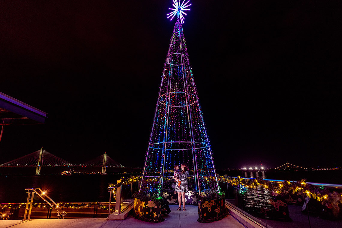 Mother and child underneath a towering tree at the South Carolina Aquarium
