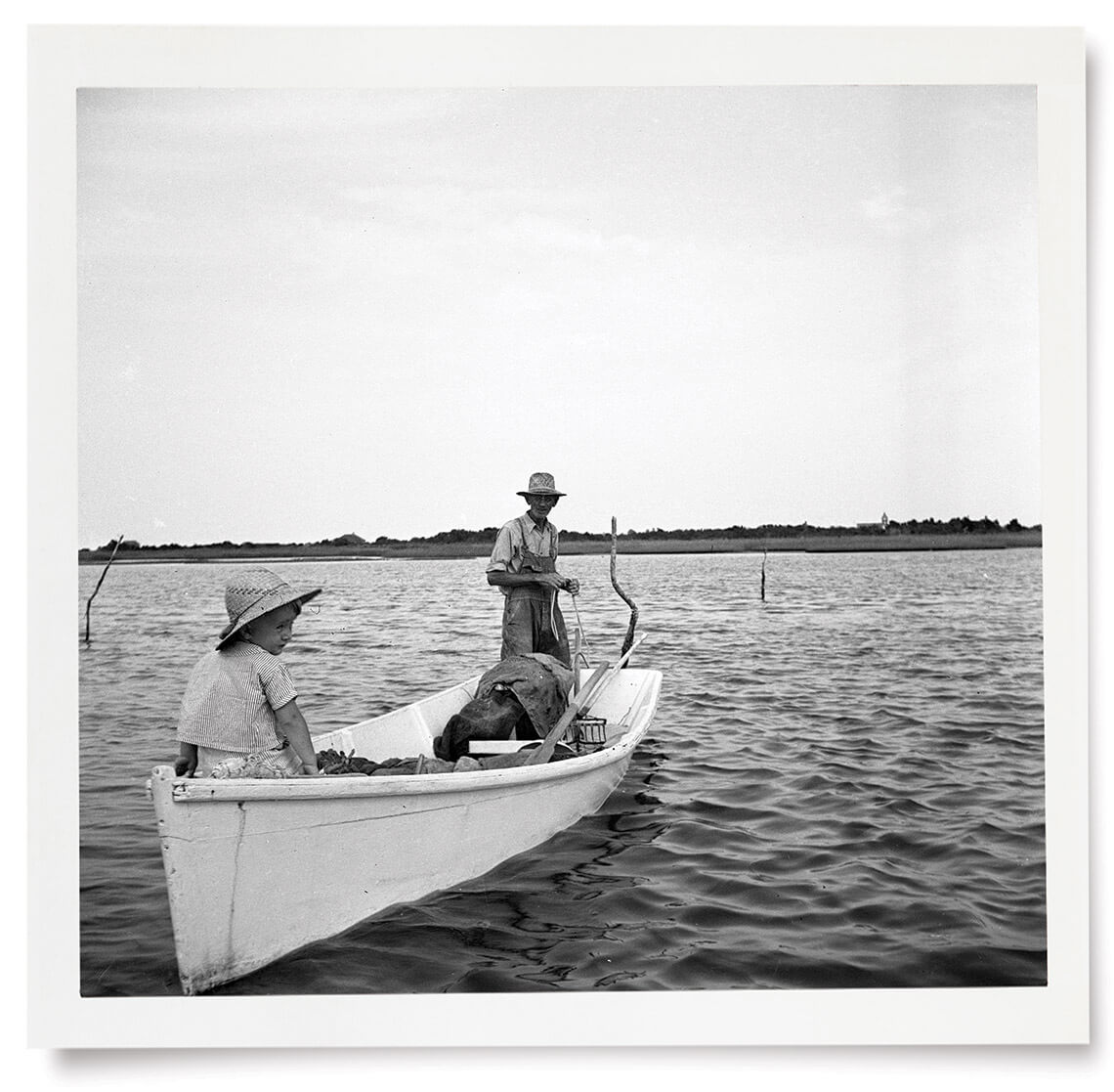 Black and white photo of people fishing