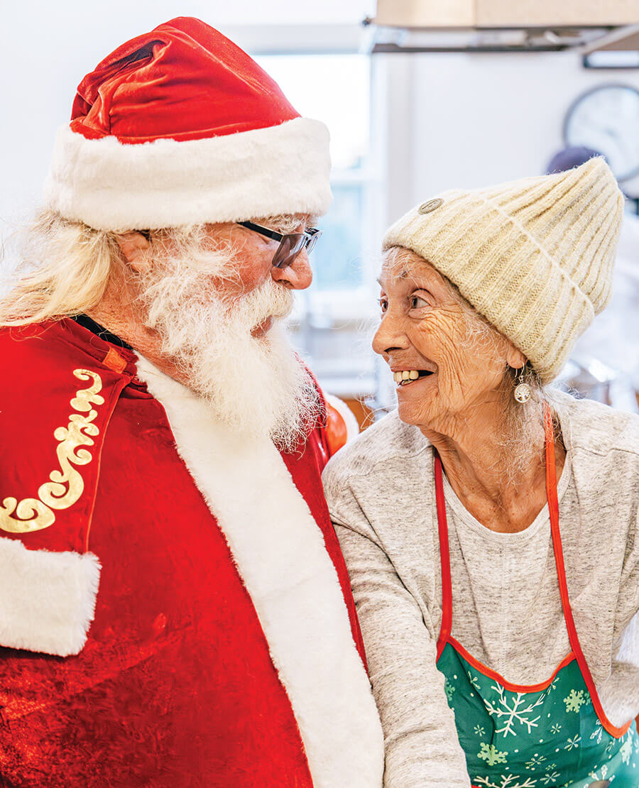 Brent Midgett dressed as Santa, standing with Connie Midgett Page