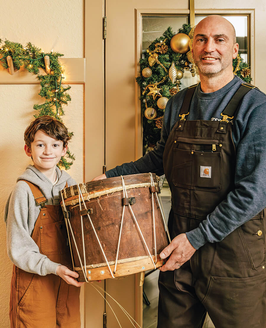Ryan Gentry and his son, Mason, hold the Drum of Old Chirstmas