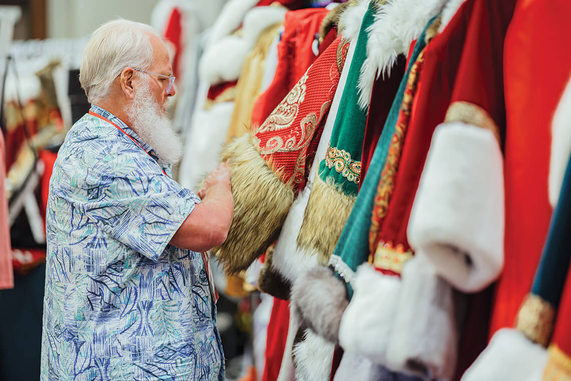 Ray Semple looks through a rack of Santa suits