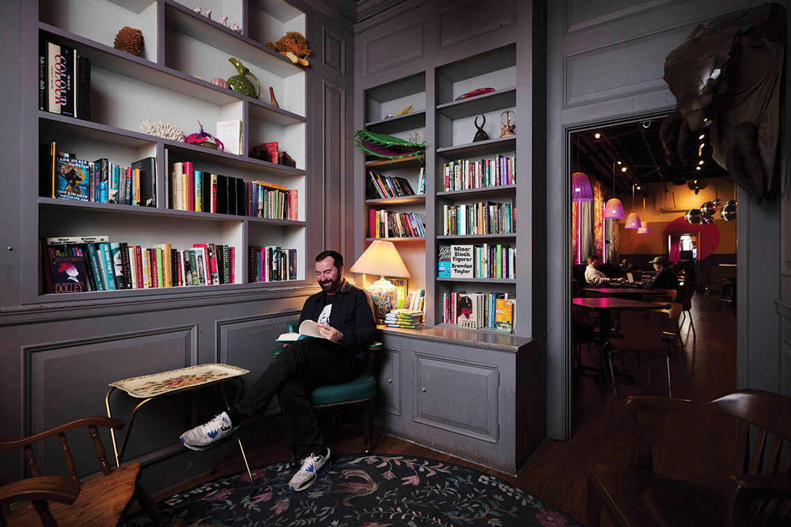 Patron reads in the reading room at Queeny's in Durham