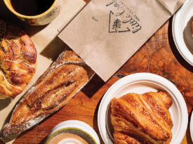 Table with focaccia, baguette, croissant, and cinnamon bun at Little Loaf.