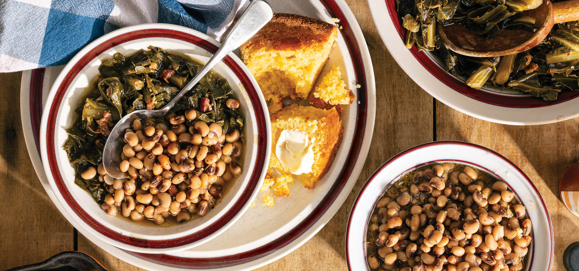 Bowl of field peas, cornbread, and collard greens on the table