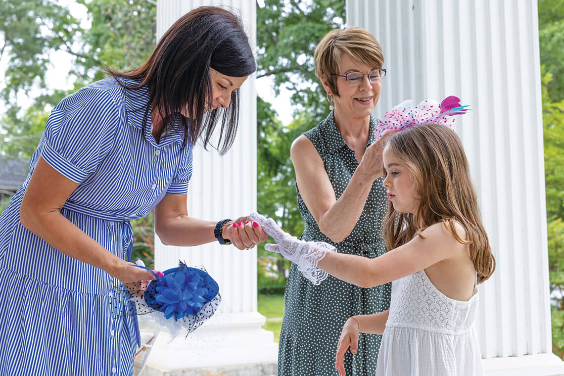 Trissia, Brandi, and Elizabeth Maples prepare for tea at the Royster House