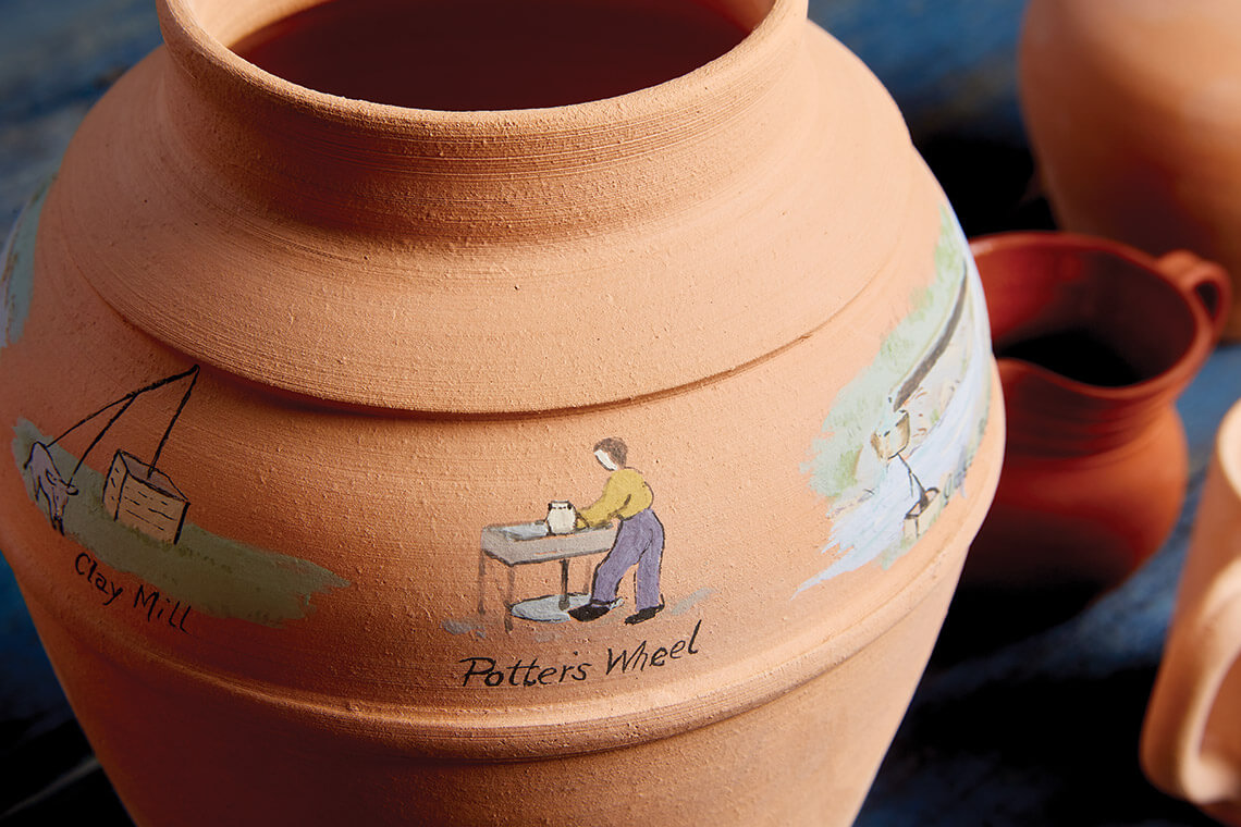 Painting details on Tobacco Road pottery