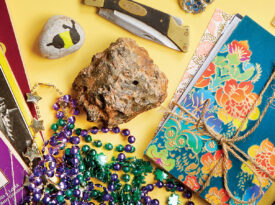 Collected thank you cards, old books, and Mardi Gras beads the author has collected