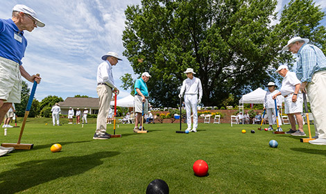 People play croquet at Arbor Acres